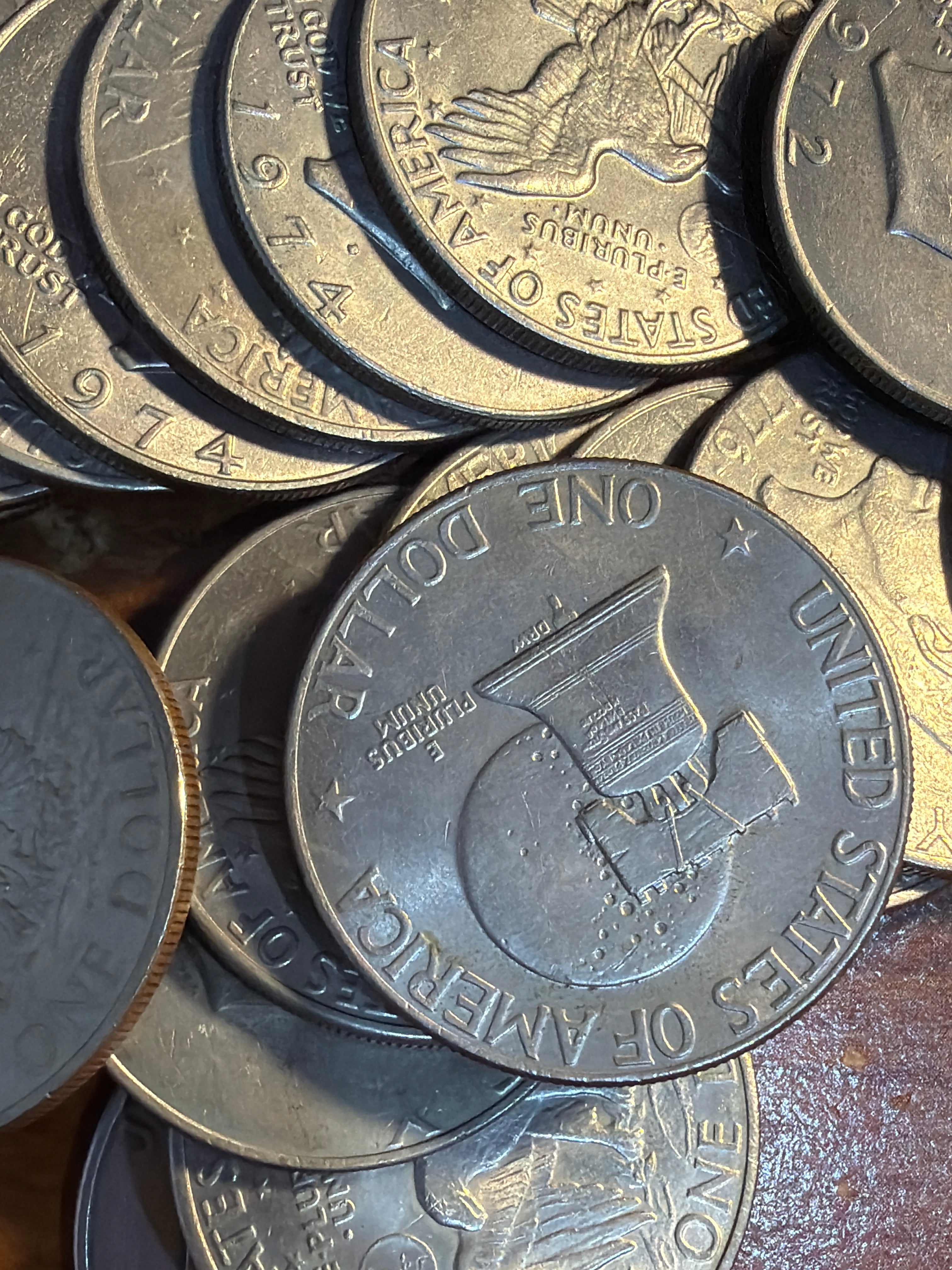 Stack of United States dollar coins on a wooden surface